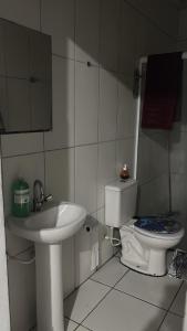 a small bathroom with a sink and a toilet at Apto em Itapecerica da Serra in Itapecerica da Serra