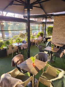 un restaurante al aire libre con mesas, sillas y vistas en Sika Crystal Apartment Arad, en Arad
