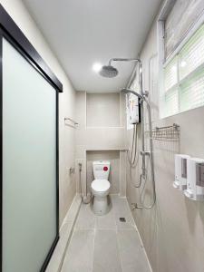 a bathroom with a white toilet and a shower at C You Home at CNX in Chiang Mai