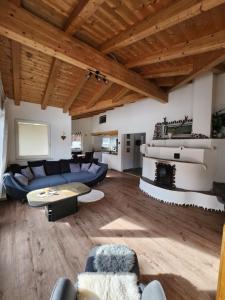 a living room with a blue couch and a table at Chalet Fini in Bramberg am Wildkogel