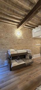 a room with two bunk beds in a brick wall at Le camere di Rigoletto B&B in Parma