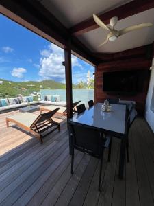 a deck with a table and chairs on a boat at Villa Leo St jean St Barthelemy in Saint Barthelemy