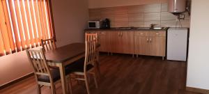 a small kitchen with a table and a refrigerator at Apartament Betula in Sovata