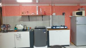 a kitchen with two refrigerators and a microwave at Cozy Home Separate Entry in Rosendal +2 photos