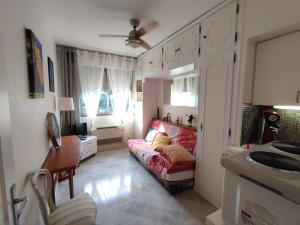 a living room with a couch and a sink at Studette 1 pièce in Menton