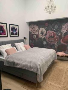 a bedroom with a large bed with a floral wallpaper at Designer loft with terrace in Neuss