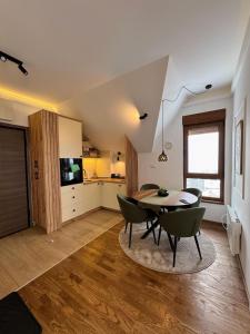 a kitchen and dining room with a table and chairs at Silver Hills in Zlatibor