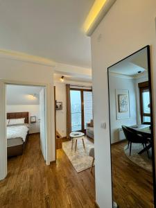 a bedroom with a bed and a mirror in a room at Silver Hills in Zlatibor