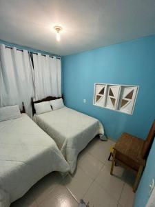 Postel nebo postele na pokoji v ubytování casa temporada pedra azul