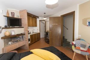 a living room with a couch and a kitchen at SAILA Monolocale VENERE in Attigliano