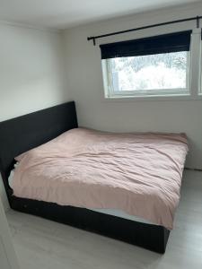 a bed in a bedroom with a window at Trondheim in Trondheim