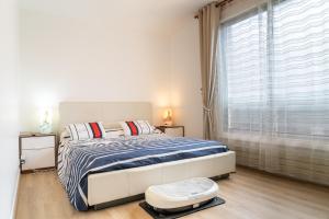 a bedroom with a large bed and a large window at Welcome chez Zouzou Paris XV in Issy-les-Moulineaux +25 photos