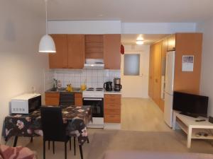 a kitchen with a table and a kitchen with a stove at Kauppala, Soini kk in Soini