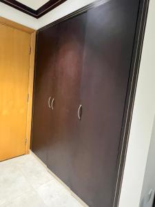 a black garage door with two handles on it at Tabs Dubai Hostel in Dubai