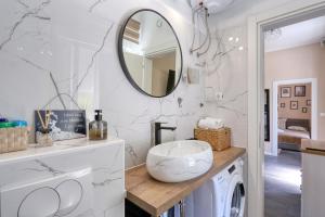 a bathroom with a washer and dryer and a mirror at Casa Lorela in Sali +30 photos