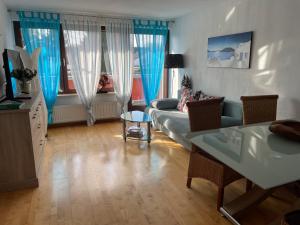 a living room with a couch and a table at Cologne Apartment – City, Trade Fair, E-Werk in Cologne