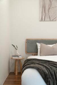 a bedroom with a bed and a side table at Cozy Homey Studios - Hoi an Coco Forest in Cam Thanh +14 photos