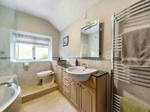 a bathroom with a sink and a toilet at 18th Century Farmhouse, England Wales Border, Breathtaking Views in Oswestry +43 photos
