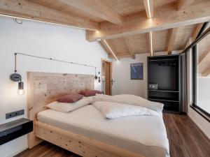 a bedroom with a large bed with a wooden headboard at Selda Chalet in Sölden