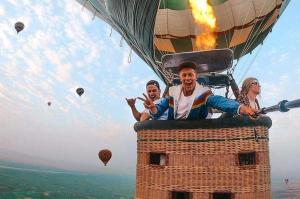 a group of people riding a hot air balloon at Golden Palace Garden in Luxor