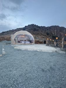 a large tent in a field with a mountain at W6 View Dome - Jabal Shams in Sa‘ab Banī Khamīs