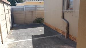 an empty alley with a fence and a building at Cozy Home Separate Entry in Rosendal