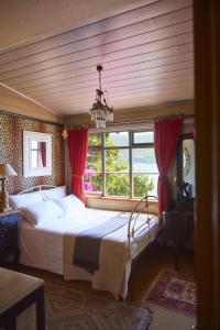 a bedroom with a large bed and a window at TwoAngels in Knysna