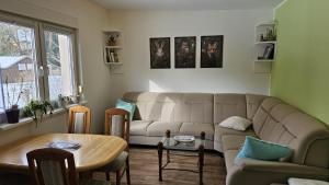 a living room with a couch and a table at Ferienbungalow Kräuterhexxe in Brandenburg an der Havel