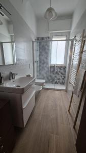 a bathroom with a shower and a sink and a toilet at Soffio Marino in Polignano a Mare +26 photos
