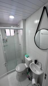a bathroom with a shower and a toilet and a sink at Apartment 10 min Cwb airport in São José dos Pinhais +6 photos