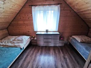Posteľ alebo postele v izbe v ubytovaní Domek Na Starej Cegielni