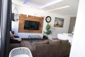 a living room with a couch and a fireplace at senator park in Cape Town