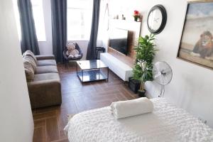 a living room with a bed and a couch at senator park in Cape Town +16 photos