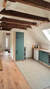 a kitchen with a blue door in a room at Central apartment in Buchholz idN in Buchholz in der Nordheide