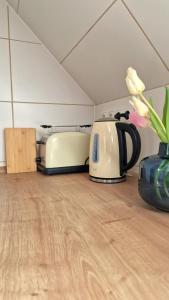 a kitchen with a toaster and a vase with flowers at Central apartment in Buchholz idN in Buchholz in der Nordheide