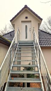 a staircase leading up to a house with a door at Central apartment in Buchholz idN in Buchholz in der Nordheide