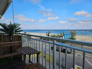 a balcony with a bench and a view of the beach at La suite (Sole) in Lido di Pomposa