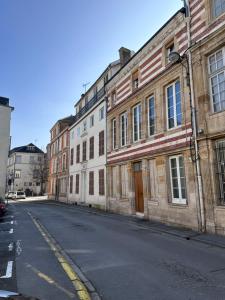 an empty street in a city with buildings at Studio le Végétal in Chalons en Champagne
