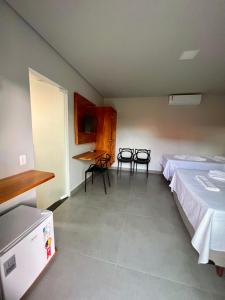 a room with two beds and a table and chairs at Pousada Ilha do Desejo in Olivença +71 photos