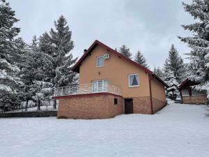 a brick house in the snow with trees at Vila Stanjevac, Sarajevo in Sarajevo