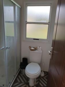 a bathroom with a toilet with a window and a shower at La Martinna 2 in Trinidad +15 photos