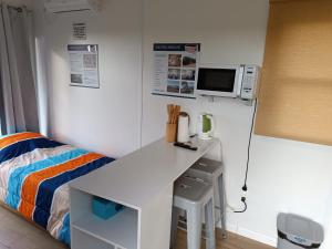 a bedroom with a white desk and a bed at La Martinna 2 in Trinidad
