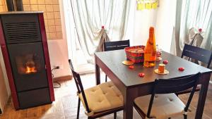 a dining room table with a bottle of wine and a fireplace at Bee Freeride Biker house in Magliolo