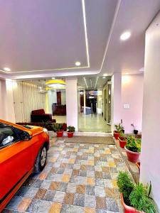 a red car parked in a lobby with plants at Hotel Royal Central Haridwar in Haridwār +39 photos