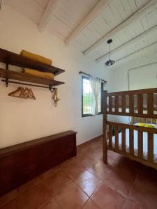 a room with a wooden bed and a window at Las Potrancas cabaña in General Alvear