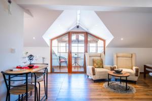 a living room with a table and chairs at Duam Apartments in Prizren