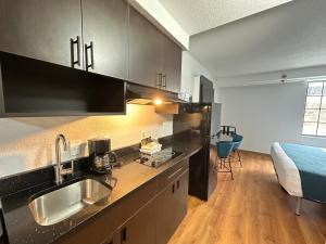 a kitchen with a sink and a bed in a room at Studio 6 Springfield VA Washington DC Southwest in Springfield
