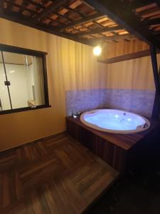 a large bath tub in a room with a window at Meu canto em Lumiar in Nova Friburgo