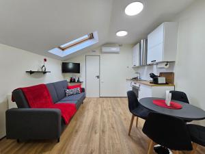 a living room with a couch and a table at ApartHotel Ritms in Krāslava