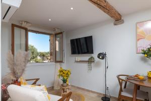 a living room with a table and a window at La Pablita by Evasion Riviera, Vieil Antibes, Remparts in Antibes